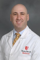 Photo of Dr. Berg in white coat